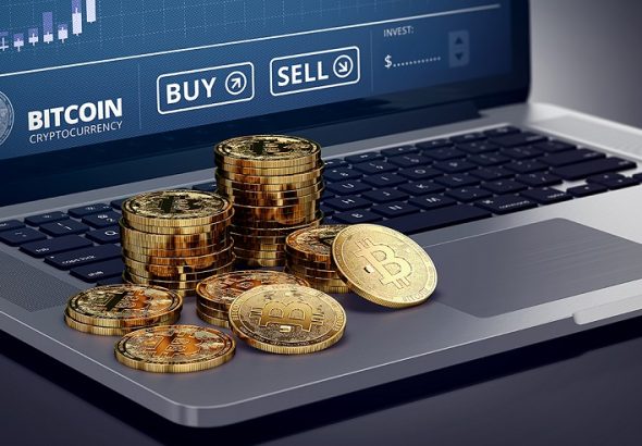 Laptop,With,Bitcoin,Chart,On-screen,Among,Piles,Of,Bitcoin.,Bitcoin